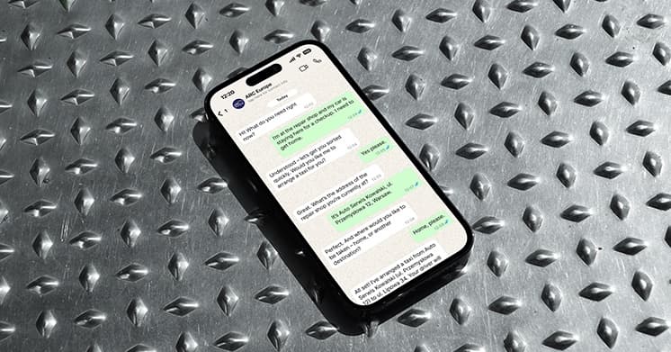 Smartphone displaying the ARC Europe chatbot conversation on a textured metal surface
