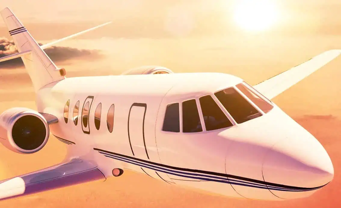 Private medical jet flying above clouds at sunset