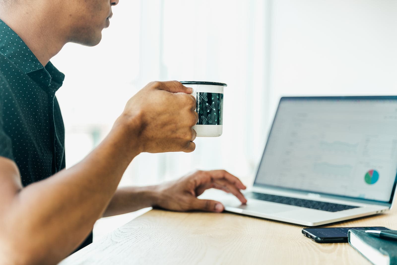 person reading analytics graphs on a laptop