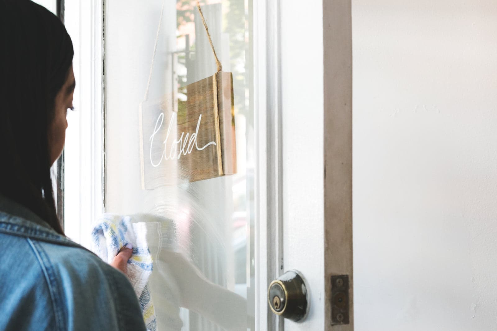 shop owner at the door of a storefront