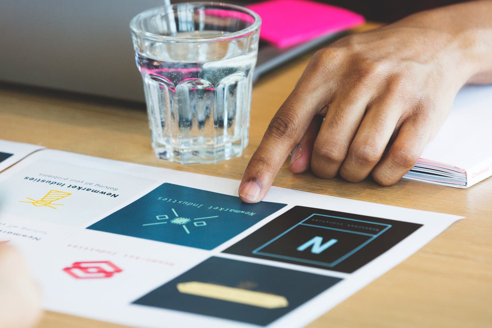 hand pointing at printed brand design options